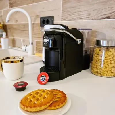 a coffee maker and a plate of waffles on a counter at Mountain Side Kopaonik in Kopaonik