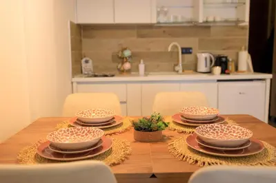 a wooden table with four bowls and plates on it at Mountain Side Kopaonik in Kopaonik
