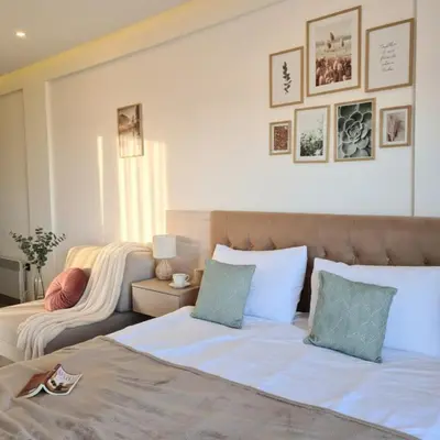 a bedroom with two beds and a couch at Mountain Side Kopaonik in Kopaonik