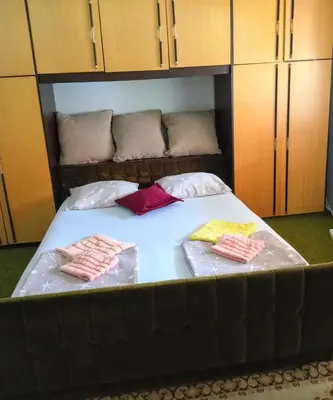 a large bed with two pillows on top of it at Panonka apartman in Leskovac