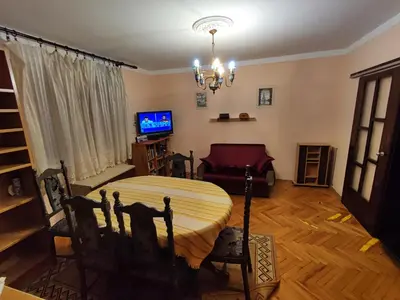 a living room with a table and a television at Panonka apartman in Leskovac