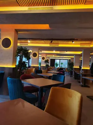 a dining room with tables and chairs in a restaurant at White Apartman Kopaonik in Kopaonik