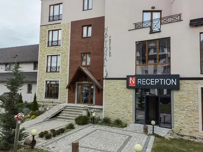 a building with a sign in front of it at White Apartman Kopaonik in Kopaonik