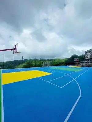 a blue and yellow basketball court with a hoop at White Apartman Kopaonik in Kopaonik