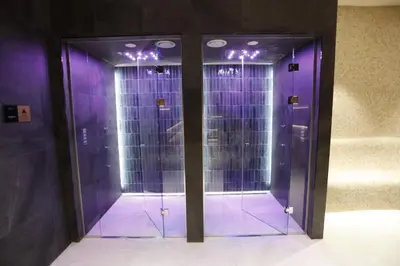 a hallway with purple glass doors in a building at Woodside Apartman Kopaonik 315 in Kopaonik