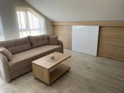 a living room with a couch and a coffee table at Vuk apartment - Milmari Resort & Spa in Kopaonik