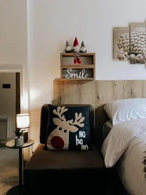 a bedroom with a pillow with a reindeer on it at Zlatokosina zona Kopaonik Milmari NLux in Kopaonik
