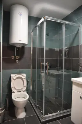 a bathroom with a shower and a toilet and a sink at Apartman LUCIJA 9D57 Kraljevi Cardaci in Kopaonik