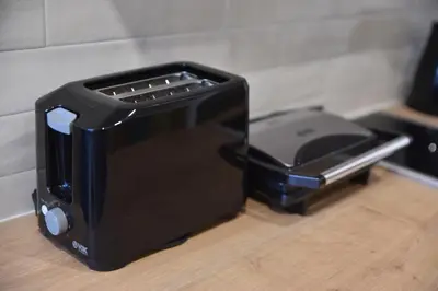 a black toaster sitting on top of a counter at Apartman LUCIJA 9D57 Kraljevi Cardaci in Kopaonik