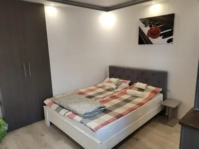 a bedroom with a bed with a checkered blanket at VIN Studio in Kruševac