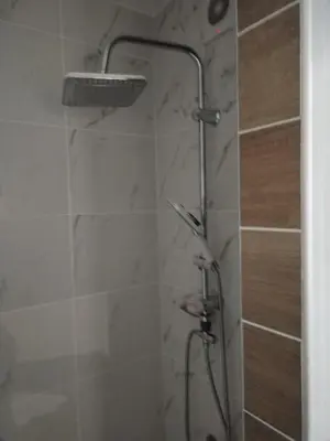 a shower with a shower head in a bathroom at VIN Studio in Kruševac