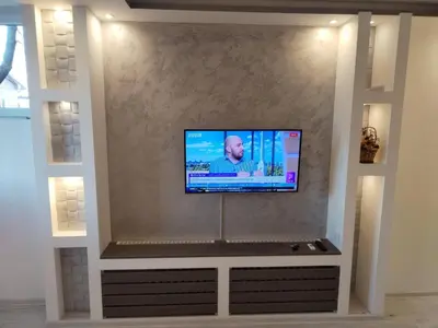 a flat screen tv on a wall in a living room at VIN Studio in Kruševac