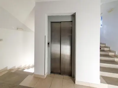 a hallway with a door and stairs in a building at Apartman Cvejic - Suncani apartmani in Brzeće