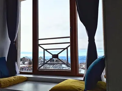 a window with a view of the eiffel tower at Apartmani Srna Milmari in Kopaonik