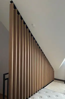 a staircase in a room with a wooden wall at Woodside Lux Duplex in Kopaonik
