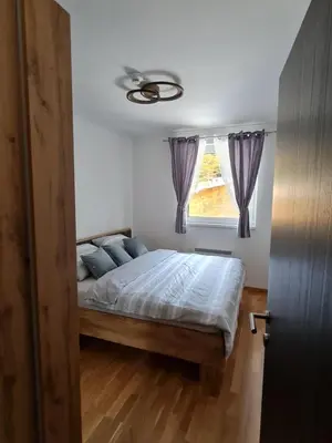 a bedroom with a bed and a window at E&M Platinum in Kopaonik
