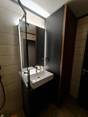 a bathroom with a white sink and a mirror at E&M Platinum in Kopaonik