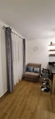 a living room with a couch and a desk at E&M Platinum in Kopaonik