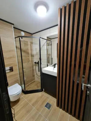 a bathroom with a toilet and a shower and a sink at E&M Platinum in Kopaonik