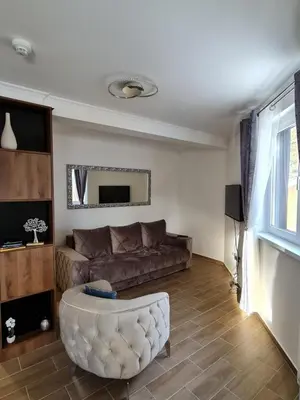 a living room with a couch and a table at E&M Platinum in Kopaonik