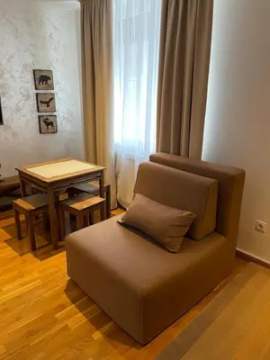 a couch sitting in a living room with a table at Kolakovic in Brzeće