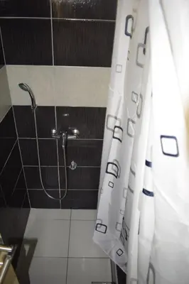 a bathroom with a shower with a shower curtain at Apartmani Gočki San in Biserske Kuće