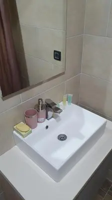 a white sink in a bathroom with a mirror at N LUX in Kopaonik
