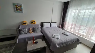 a bedroom with two beds and a table and a window at N LUX in Kopaonik