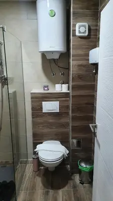 a small bathroom with a toilet and a sink at N LUX in Kopaonik