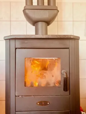 a stove with a fire inside of it at Petra in Kopaonik