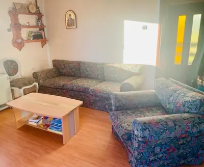 a living room with a couch and a table at Petra in Kopaonik