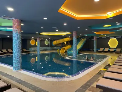 a indoor pool with a slide in a hotel at Jankov konak in Kopaonik