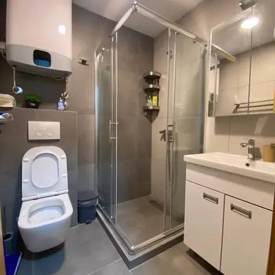 a bathroom with a shower and a toilet and a sink at Jankov konak in Kopaonik