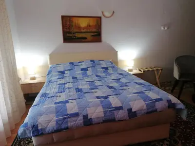 a bedroom with a blue and white quilt on a bed at Markov konak in Babušnica