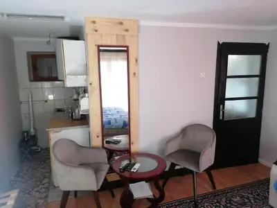 a room with two chairs and a table and a mirror at Markov konak in Babušnica