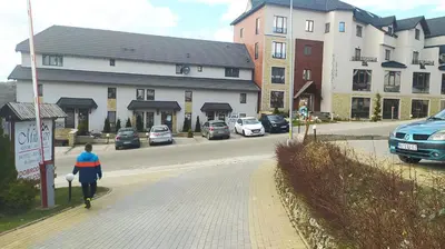 a woman walking down a street in a city at Apartman Tiva - Milmari Resort-garažno mesto-GRATIS in Kopaonik