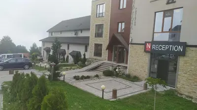 a street sign in front of a building with a parking lot at Apartman Tiva - Milmari Resort-garažno mesto-GRATIS in Kopaonik