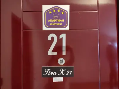 a red door with a sign on it with the number fourteen at Apartman Tiva - Milmari Resort-garažno mesto-GRATIS in Kopaonik