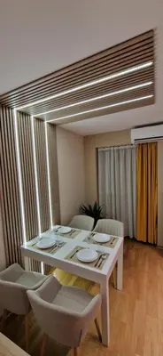a white dining room table with chairs and a white table and chairsktop at Apartman La Campanella 1 in Vrnjačka Banja