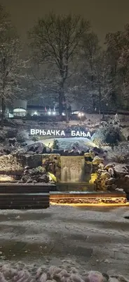 a fountain with the words bibliographybiabiabia in the snow at Apartman La Campanella 1 in Vrnjačka Banja