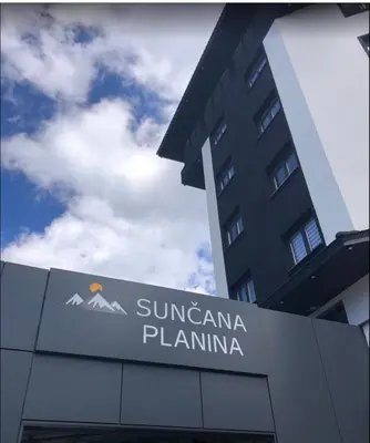 a sign in front of a building with a mountain at Diamond Kopaonik Centar in Kopaonik