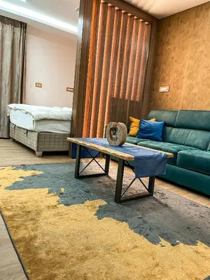 a living room with a couch and a table at Diamond Kopaonik Centar in Kopaonik