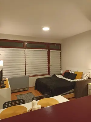 a room with two beds and a table and chairs at MonteCasa in Vrnjačka Banja