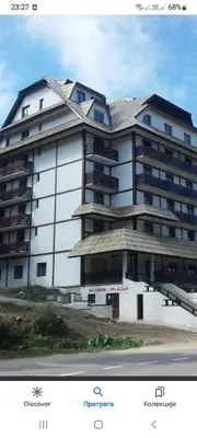 a large white building with a roof on top of it at Kopaonik in Kopaonik