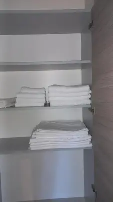 a stack of towels on a shelf in a closet at Kopaonik in Kopaonik
