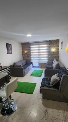 a large living room with couches and a table at Kopaonik in Kopaonik