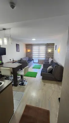 a living room with a couch and a table at Kopaonik in Kopaonik