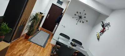 a room with a hallway with a clock on the wall at Marinkovic stan na dan in Vranje