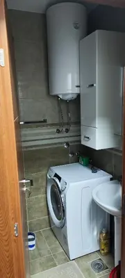a small bathroom with a washing machine and a sink at Marinkovic stan na dan in Vranje