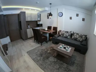 a living room with a couch and a table at Apartman Leki in Kopaonik